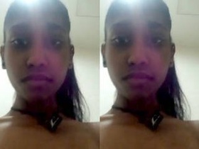 A seductive young woman pleasures herself with her fingers