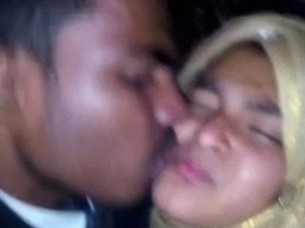 A young couple shares a passionate kiss in amateur video