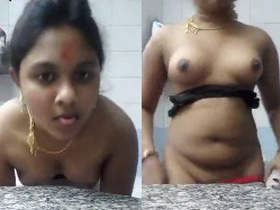 Watch as a sexy desi bhabi strips and shows off her pussy, ass, and tits
