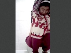 Watch as a woman shows off her pee in a bathroom
