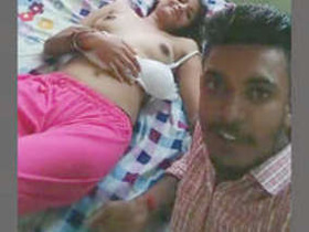 Indian couple prepares for intimate moment in bedroom