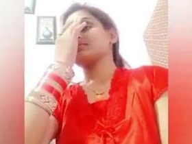 A young woman smiles on camera and shows off her fashion sense in a sex video