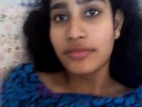 A smiling girlfriend pleasuring herself with her fingers and tongue